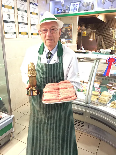 allan bennett holding gold award and sausages